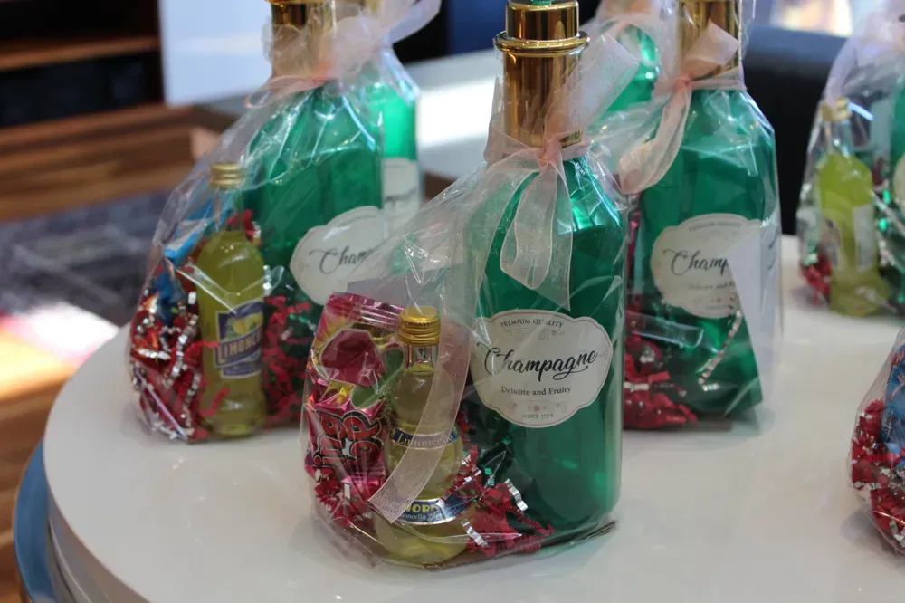 Champagne-bottle favours bagged for guests